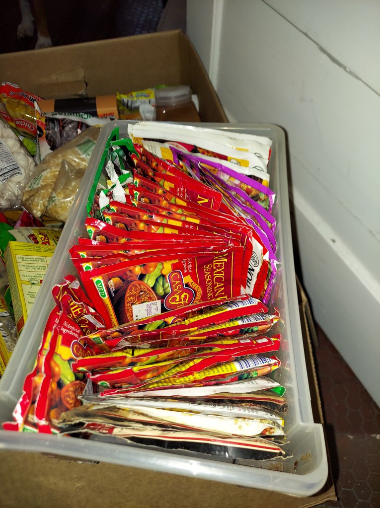 a shoe-box sized plastic drawer crammed full of taco seasoning packets